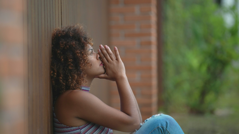 Trusting God — Christian woman praying, surrendering uncertainty and taking the next faithful step